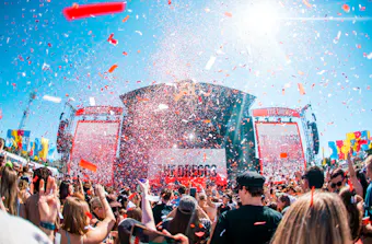Spilt Milk stage with confetti covered a packed crowd. 