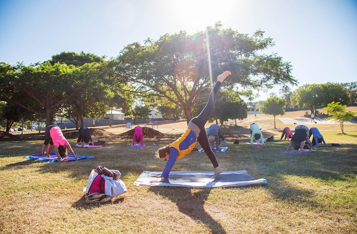 Person doing yoga pose in park.