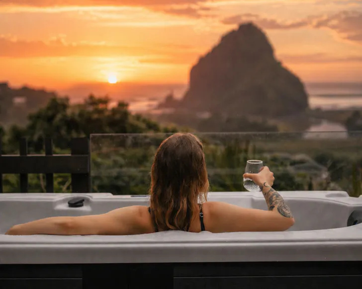 The putdoor bath with a view of Lion rock at The Little Louises best romantic stays near Auckland