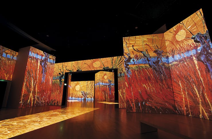 The Red Vineyard is projected onto a wall.