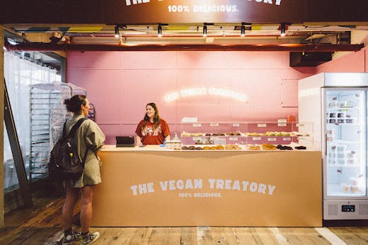 Cute minimalist cookie stall shopfront with a neon sign that says