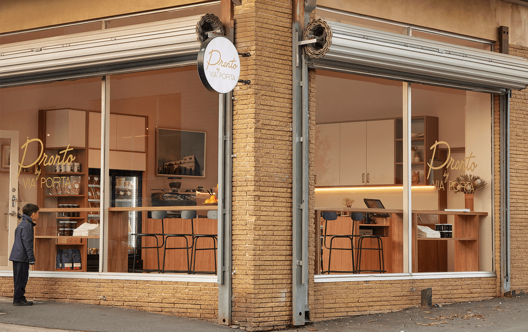 The outside of one of the best cafes in Melbourne with shutter doors and windows.