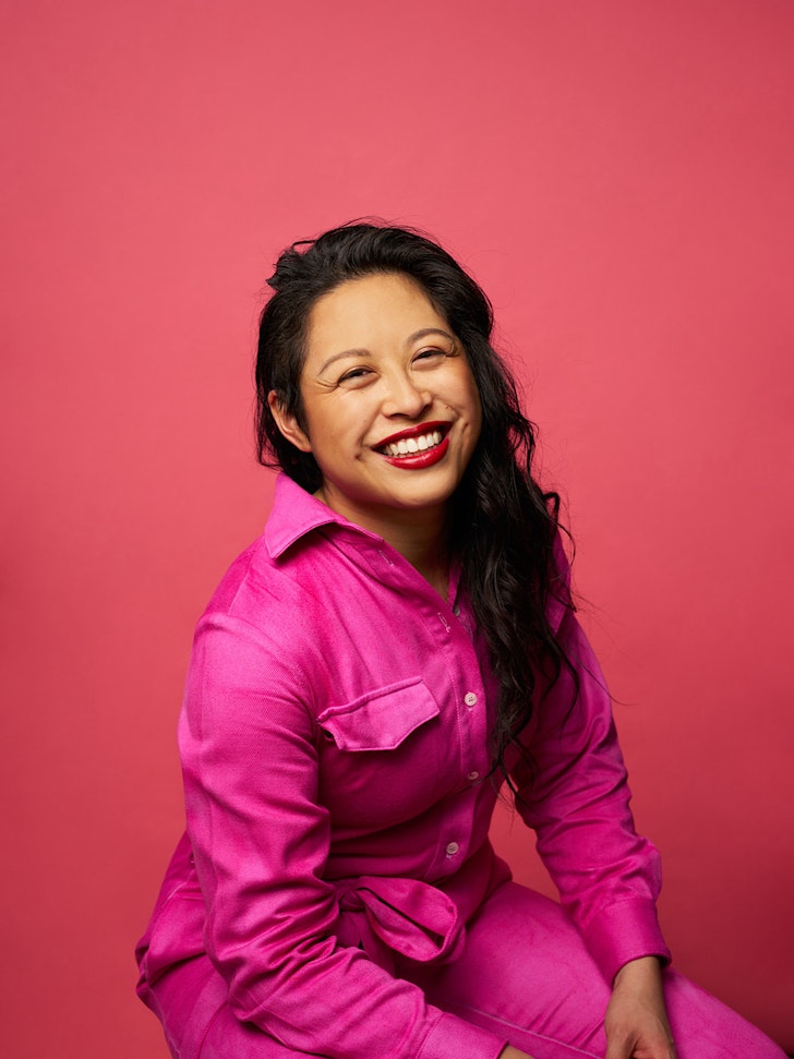 Vicki poses in a bright pink suit.