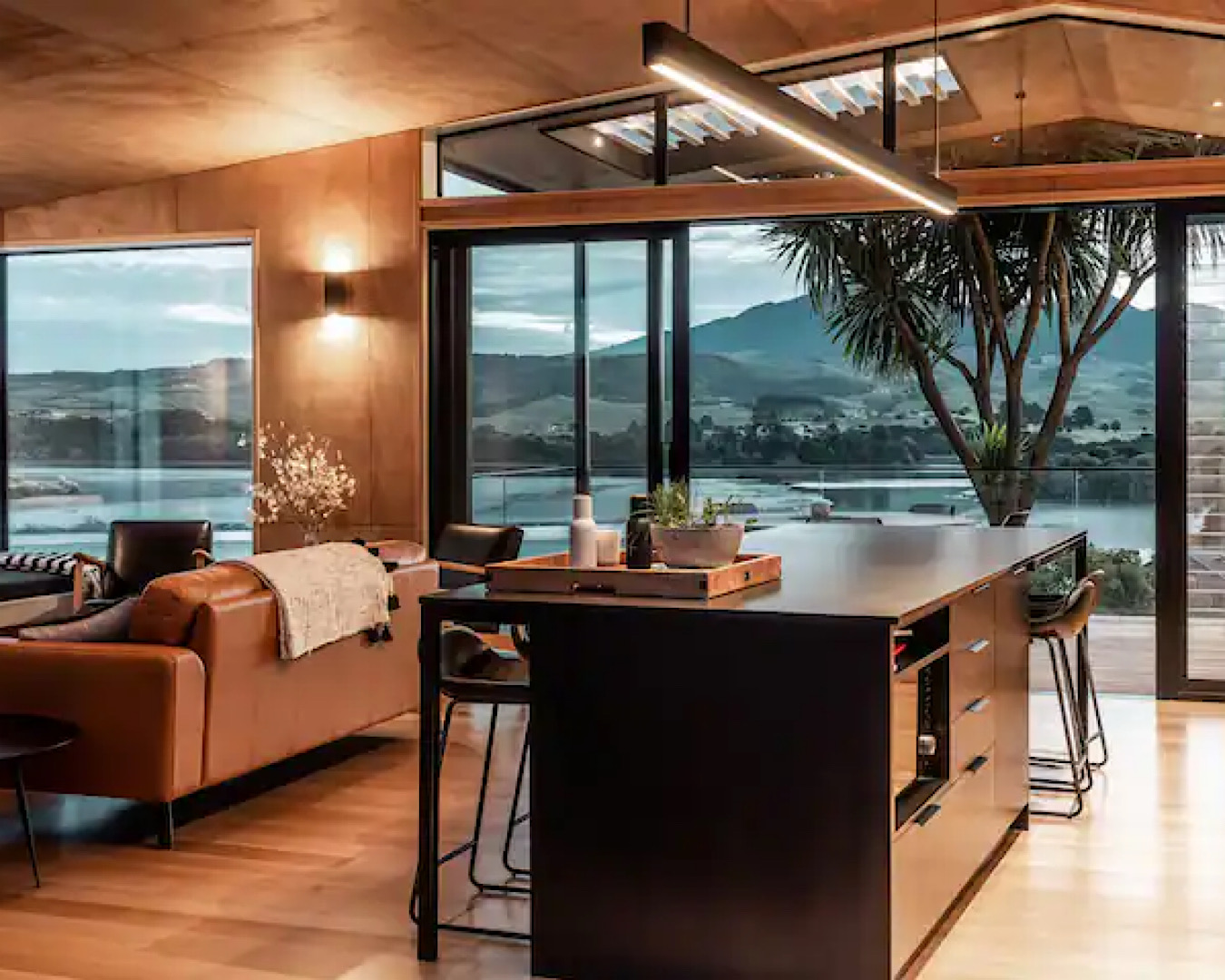 A stunning modern dining-kitchen area that looks out to jaw-dropping views of Kaitoke Bay and Mt Karioi. 