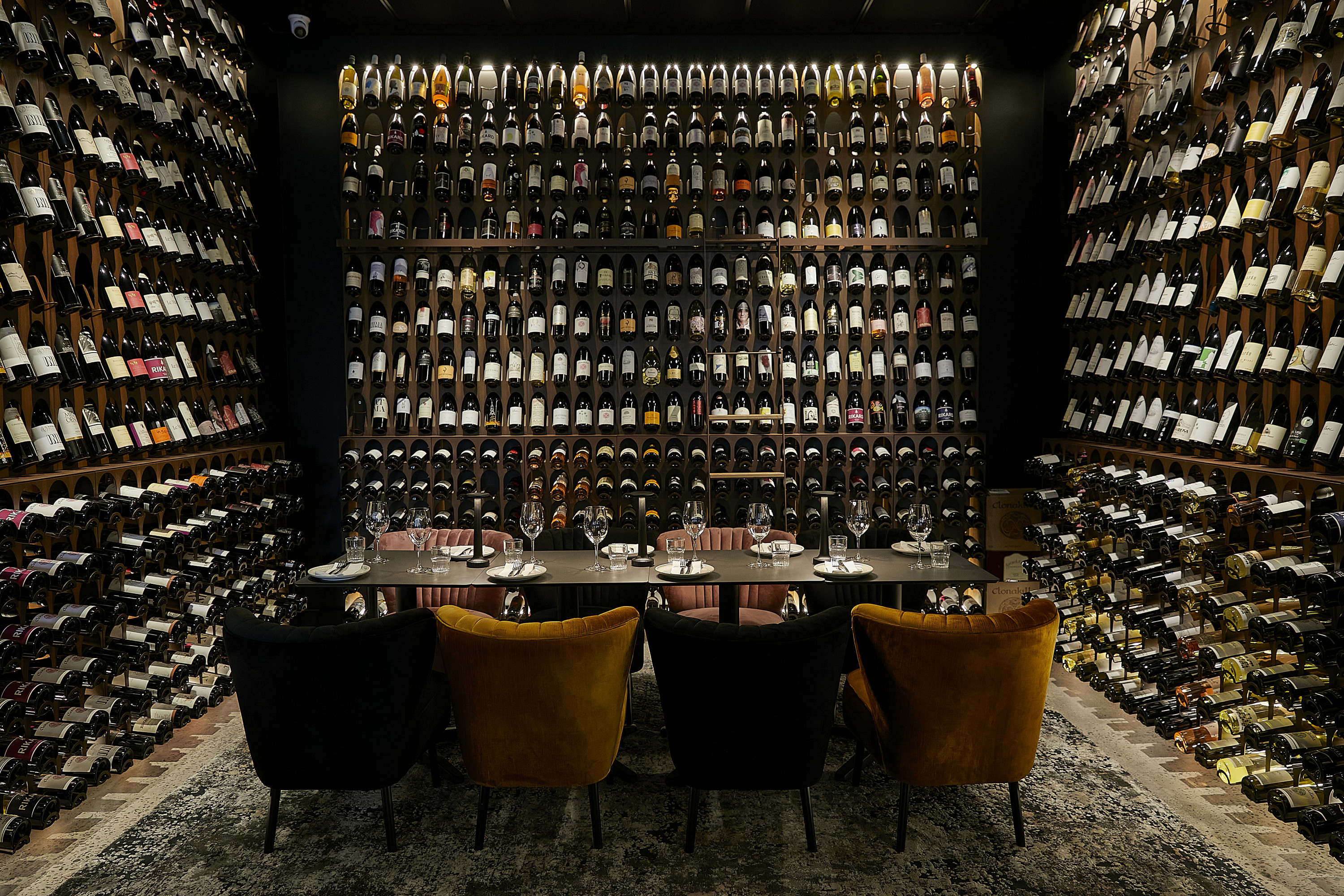 a wall stacked with wine bottles