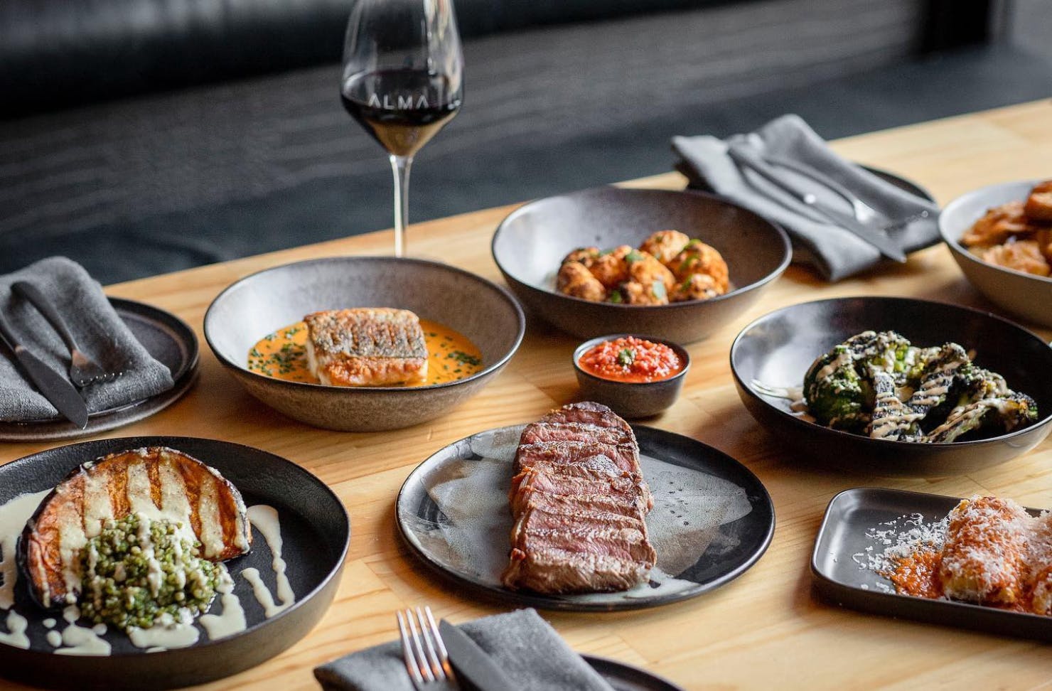 Table covered in plates of delcious food at Alma Restaurant in Geelong