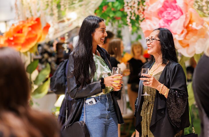 People talking under flowers