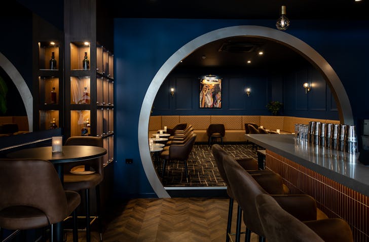 the interior of a blue and gold whisky den