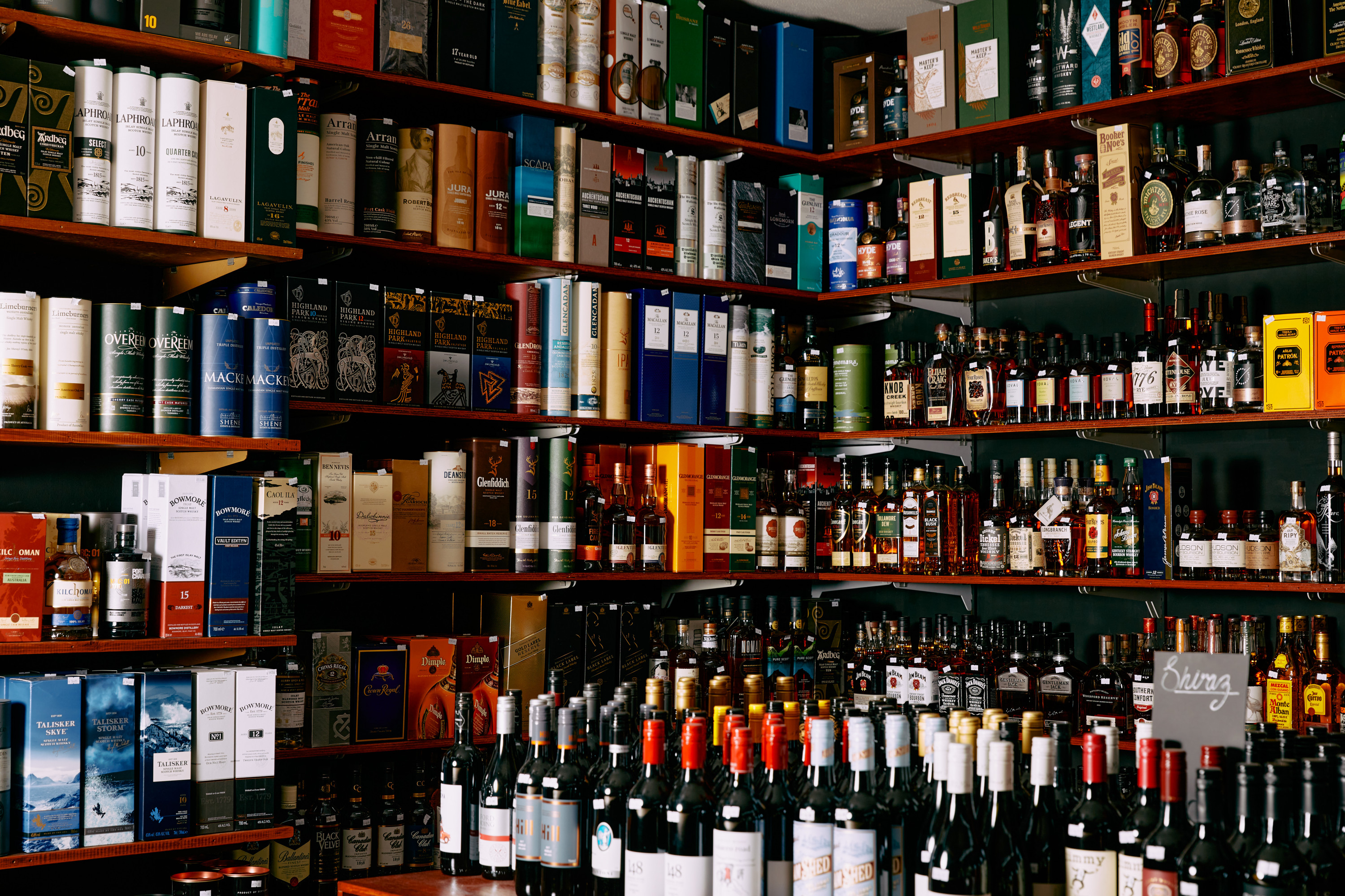 A shelf full of fine liquor.
