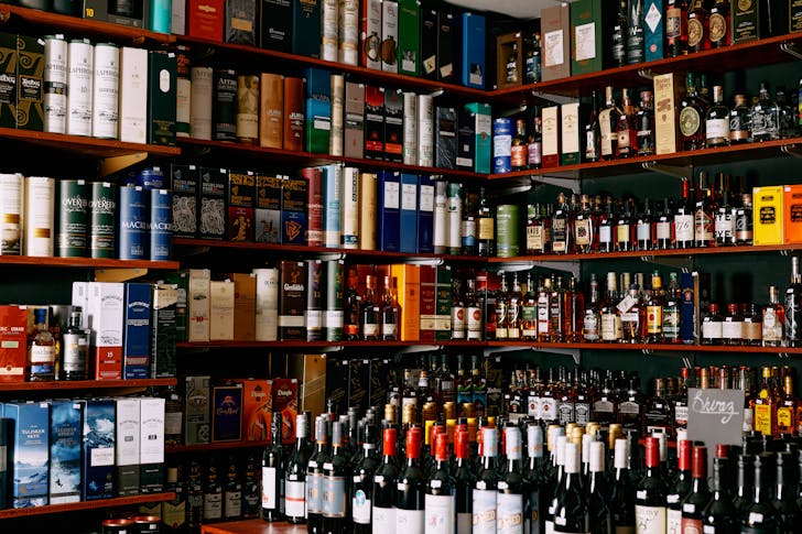 A shelf full of fine liquor.