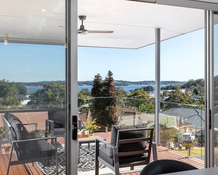 Dining table on balcony looking out to ocean view. 