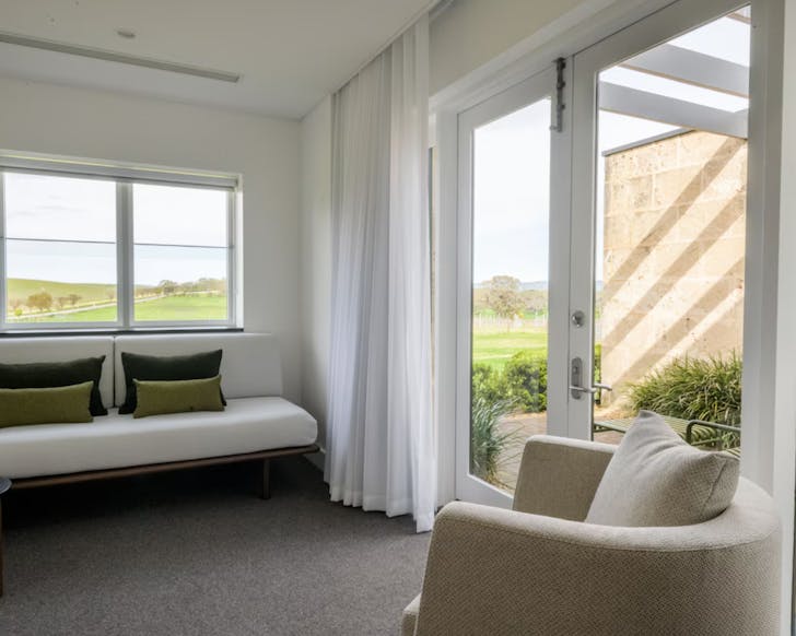 Two chairs under a window