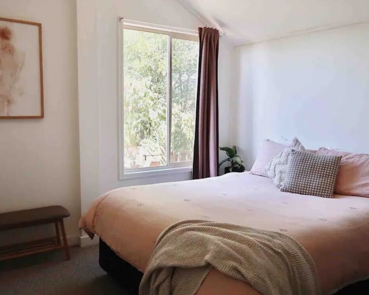 Pink bed next to window