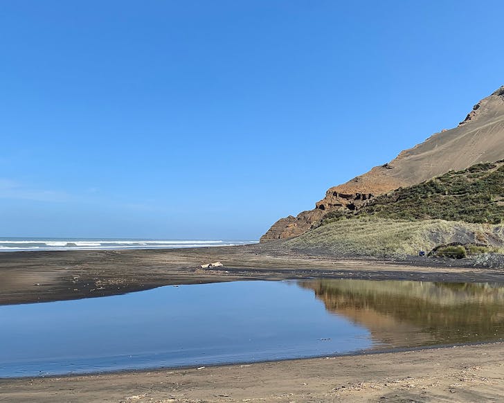 Water next to a nice looking beach.