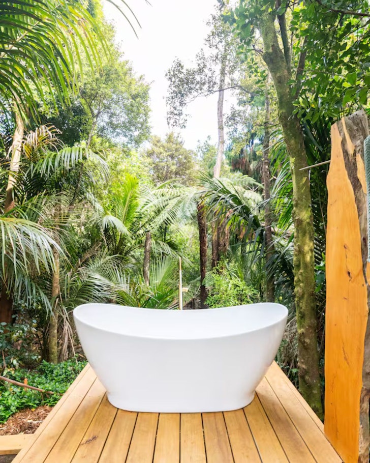 The outdoor bath at Waitakere Bird's Nest one of the best Auckland romantic Airbnb stays