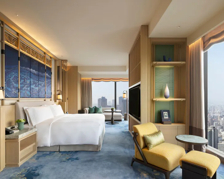 A deluxe room with city views and Japanese-style art at Waldorf Astoria Osaka. 