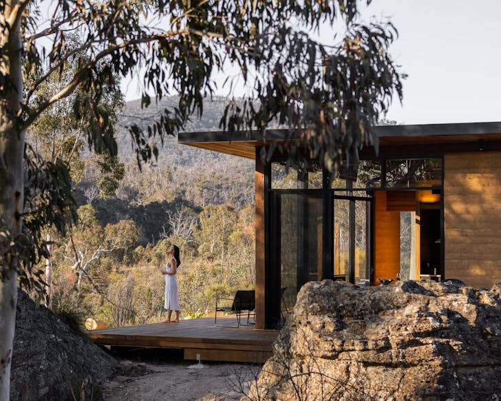 A woman looks at the view at Wambal Cabin nature Airbnb NSW