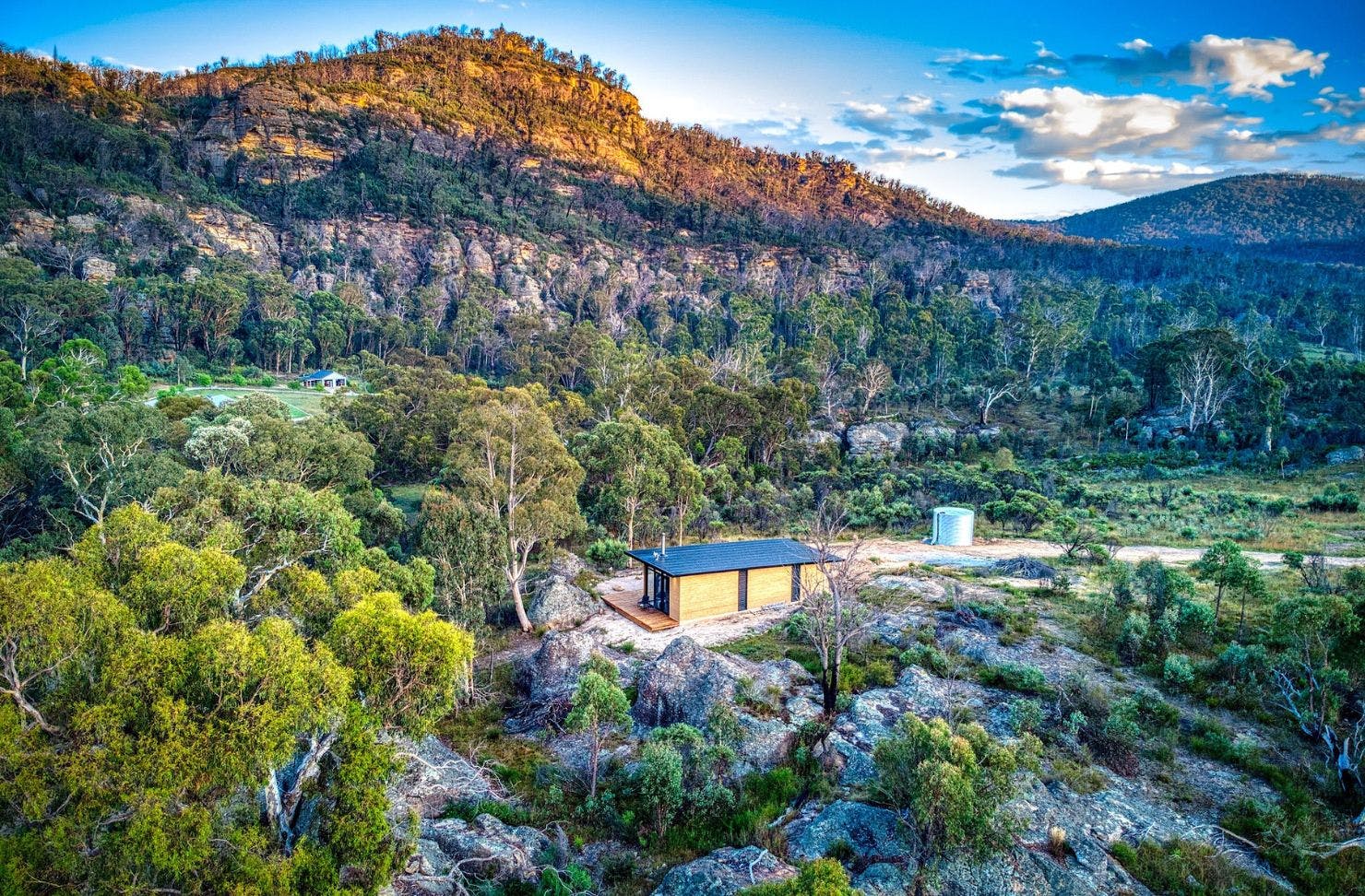 Wambal Cabin with mountains behind it