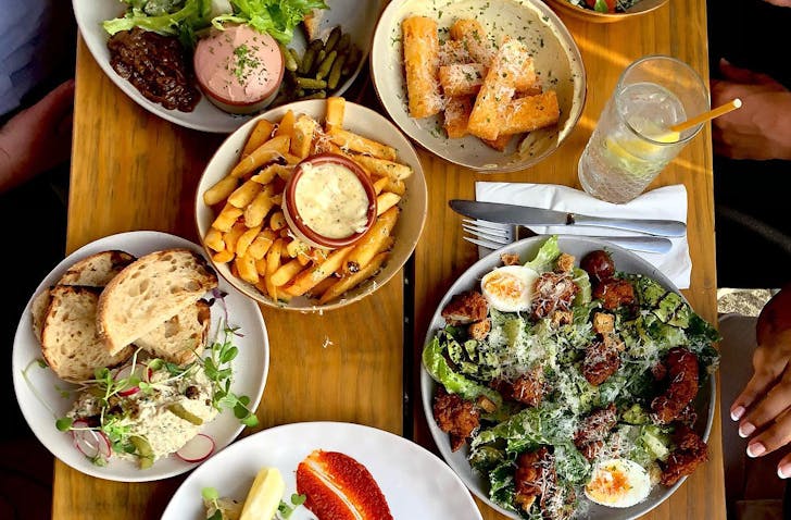 People tuck into a feast at Ambler, one of the best places open this Matariki public holiday in Auckland.