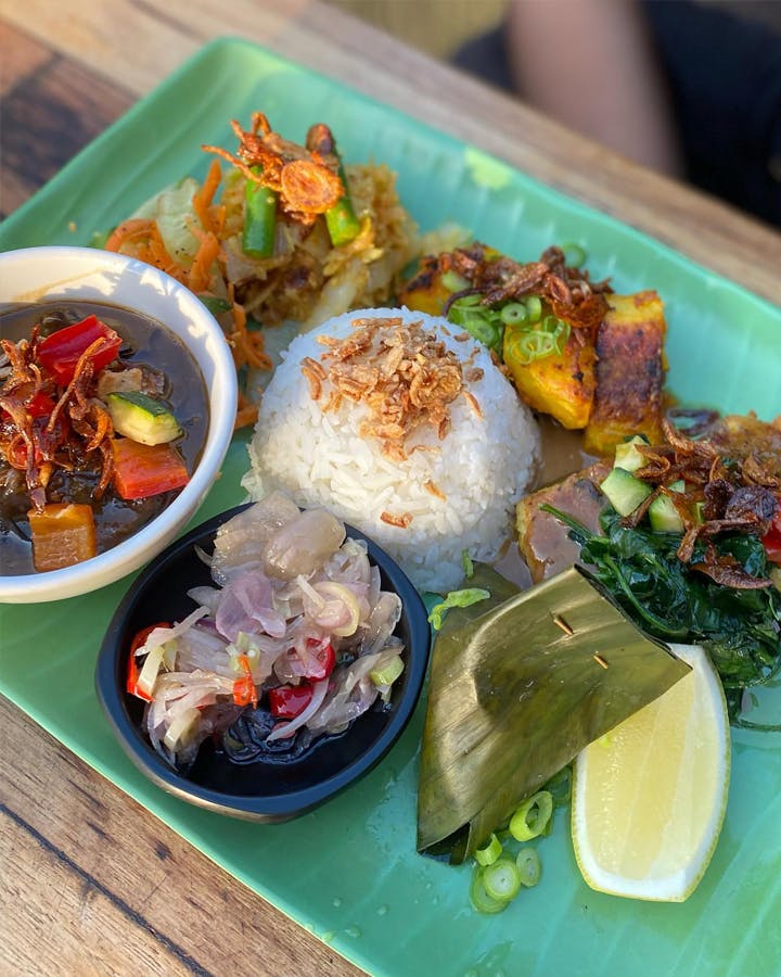 A plate with rice, sambal and banana leaf at a best Indonesian restaurant Melbourne. 