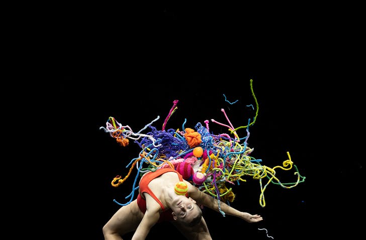 Person with balls of yarn dancing.