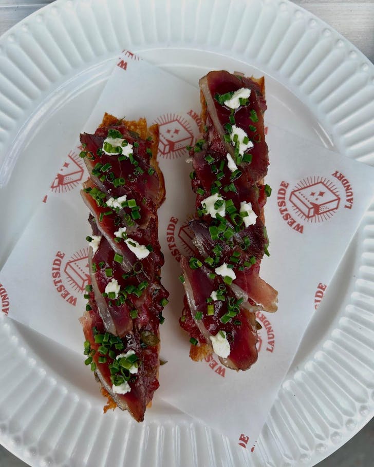 Steak tartare on foccacia on table.