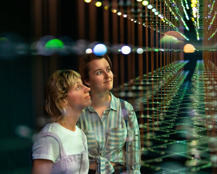 Two women looking at artwork