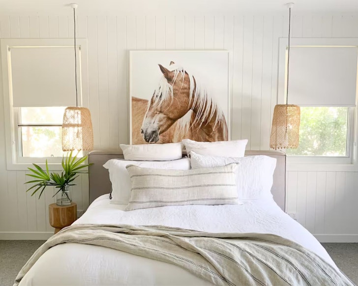 A view of the big horse picture in the master bedroom at Wildflower Beach House one of the best Noosa Airbnbs