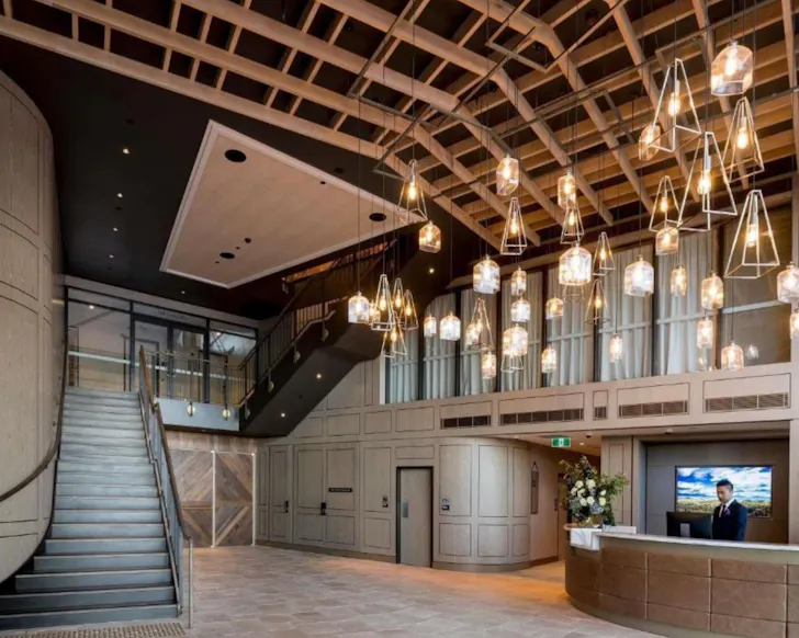 A sculptural roof and grand staircase at the entrance of the William Inglis Hotel.