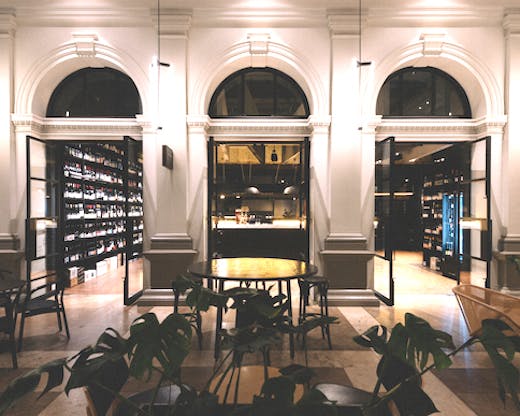Looking into the Wine Merchant across the outside tables and plants