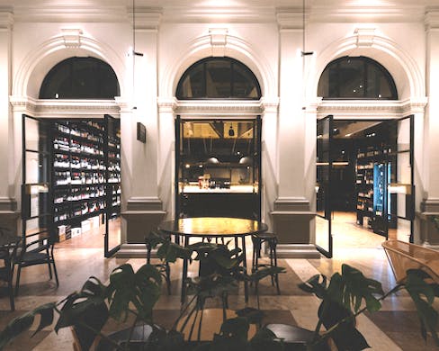 Looking into the Wine Merchant across the outside tables and plants