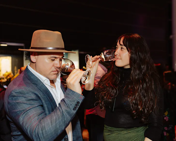 Two winos taste some exquisite wine at Winetopia. 