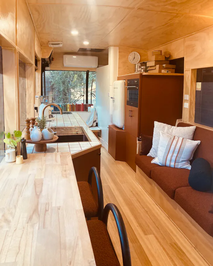 A view of the living space inside a bus at Woodland Way Stay one of the best tiny houses in Australia