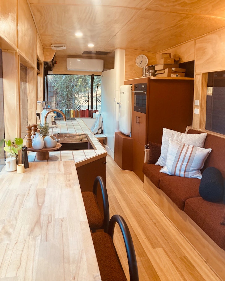 A view of the living space inside a bus at Woodland Way Stay one of the best tiny houses in Australia