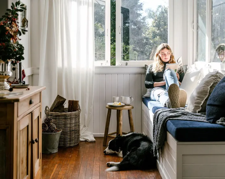 A woman and her dog at Woolcott Cottage one of the best pet-friendly Gold Coast Airbnbs