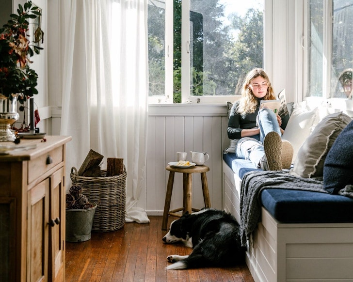 A woman and her dog at Woolcott Cottage one of the best pet-friendly Gold Coast Airbnbs