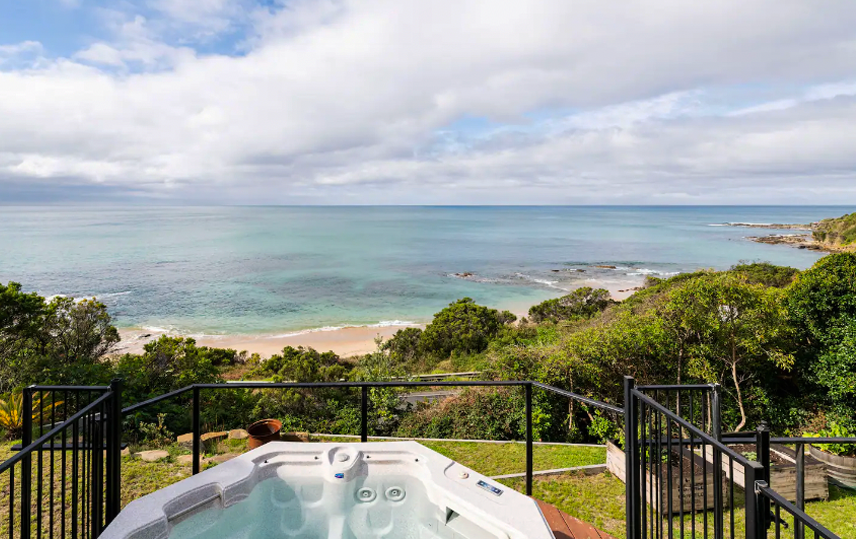 A spa overlooking the ocean at a best outdoor spa and bath airbnb.