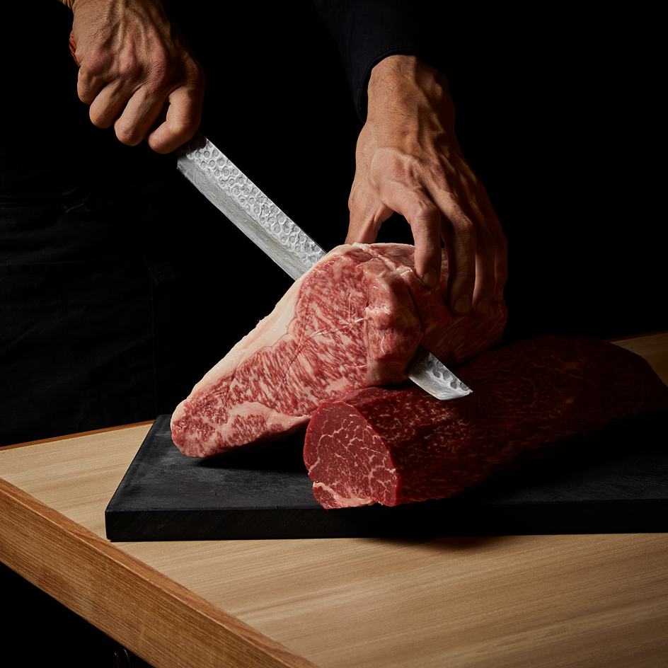A person cutting a steak at a South Yarra restaurant