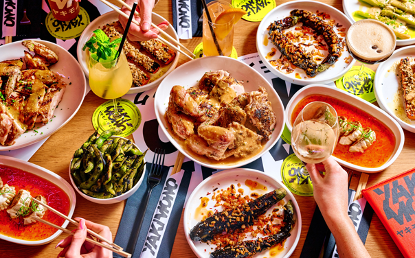 A table filled with different food dishes and cocktails at a top bottomless brunch melbourne.