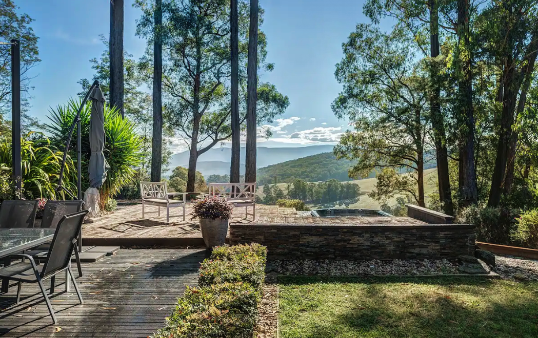 A large outdoor spa looking out onto a valley at one of the best airbnbs in Victoria.