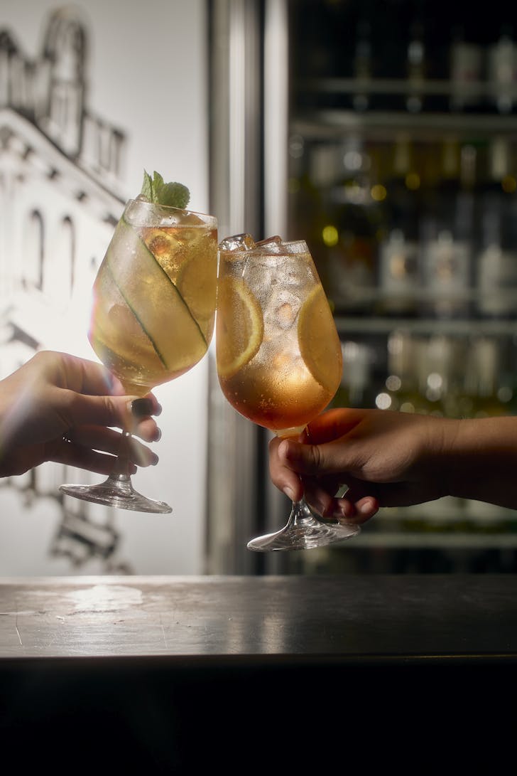 glasses of cocktails clinking at the Yarra Valley Grand