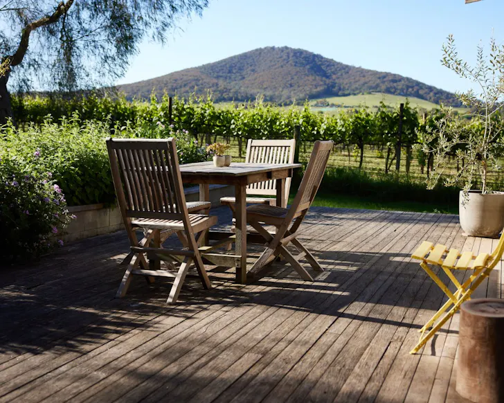 The outdoor seating with a view of the vines at Yarra Valley Vineyard Cottage best Victoria Airbnbs