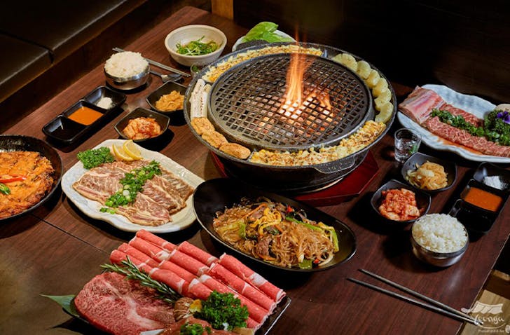 A korean BBQ surrounded by fresh cuts of meat at one of the best Korean restaurants Melbourne has to offer called Yeonga