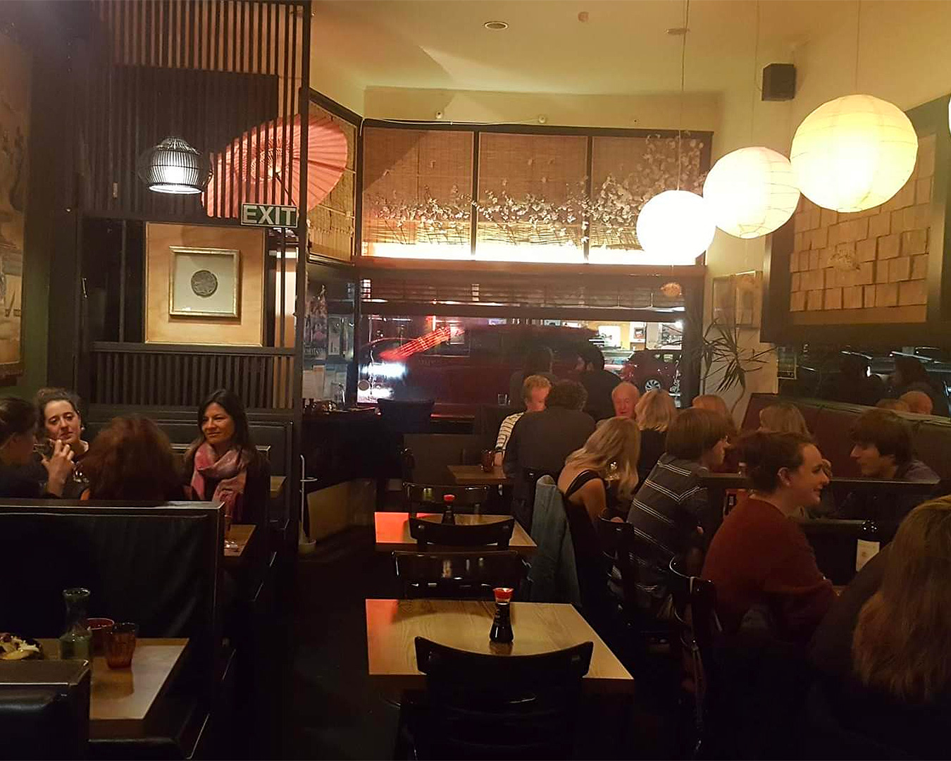 People dine in the busy dining room at Yuzu, one of the best Japanese restaurants in Auckland.