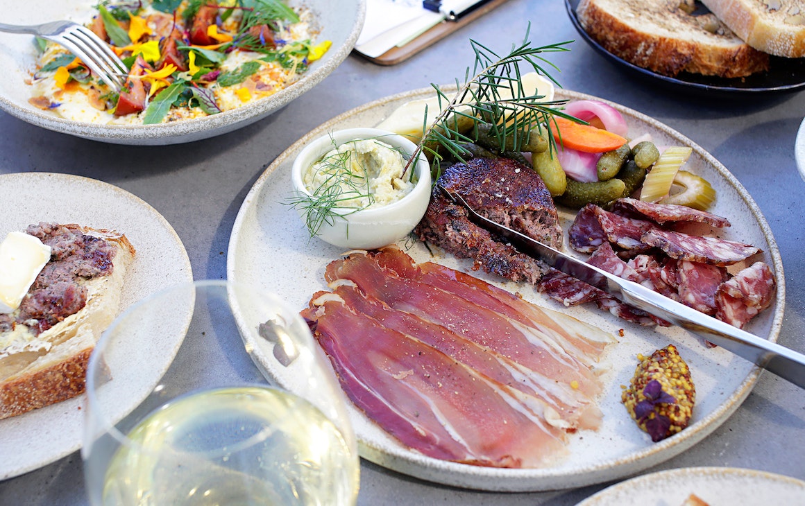 SKØL, a table topped with share plates of food