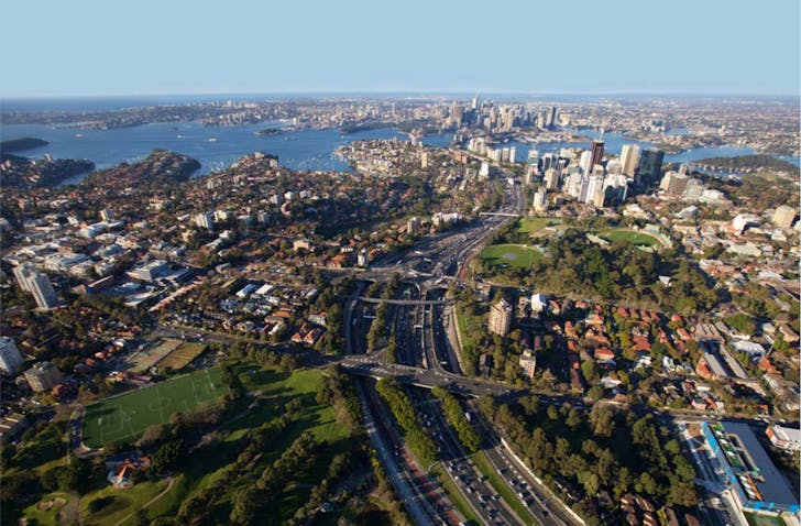 Birds-eye view of the Sydney Warringah Freeway with distant views of the Harbour Bridge in the background.