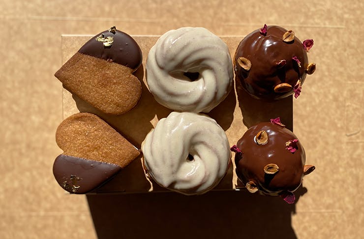 Several pastries on display atop a wooden board.