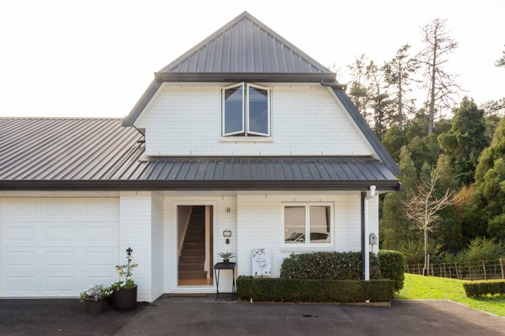 The white exterior of A Bit Of Heaven On Earth one of the best Auckland Airbnbs