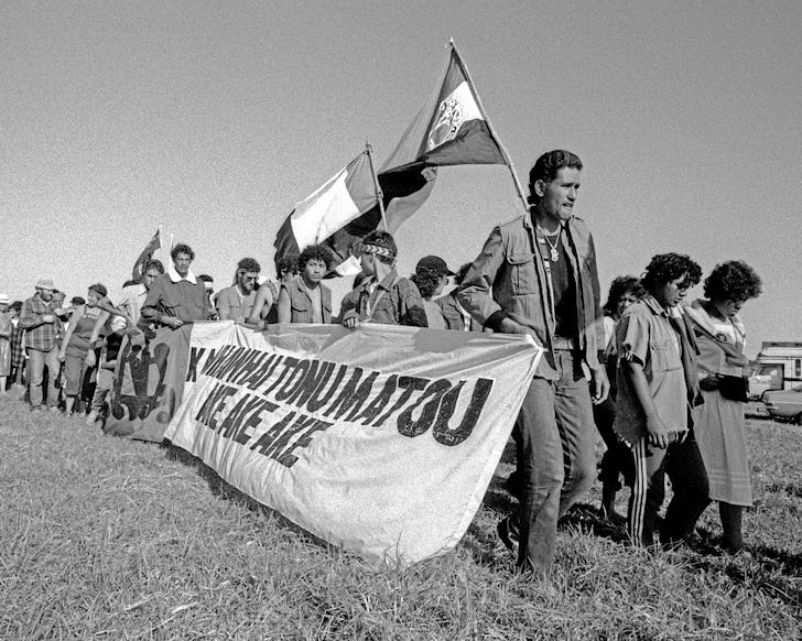 A black and white photo of protesters marching in circa 1970s New Zealand.