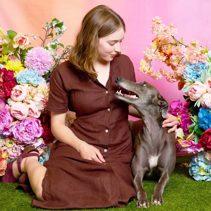 A rescue dog looks up at its owner for a Creatures & Co. photoshoot.